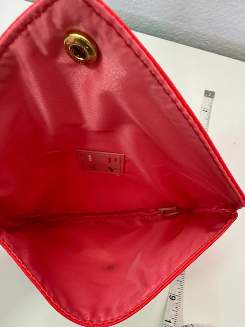 This is a red Ipsy Sealed with a Kiss makeup bag NWOT